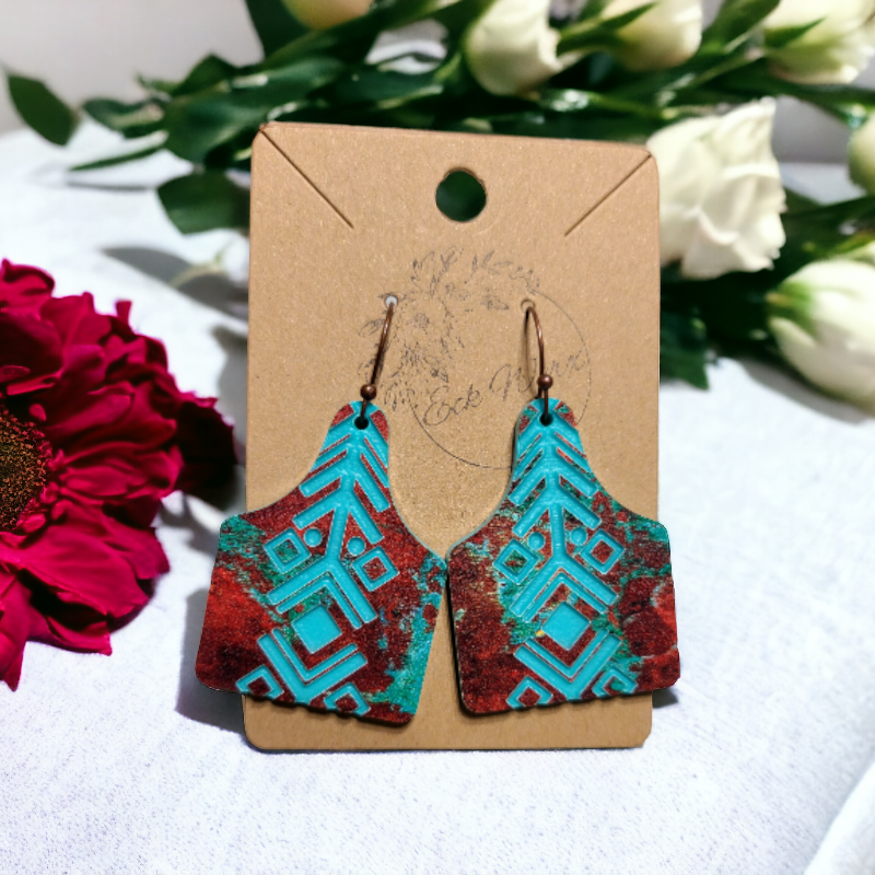 Copper and Teal Cowtag Earrings Engraved with an Aztec Design.